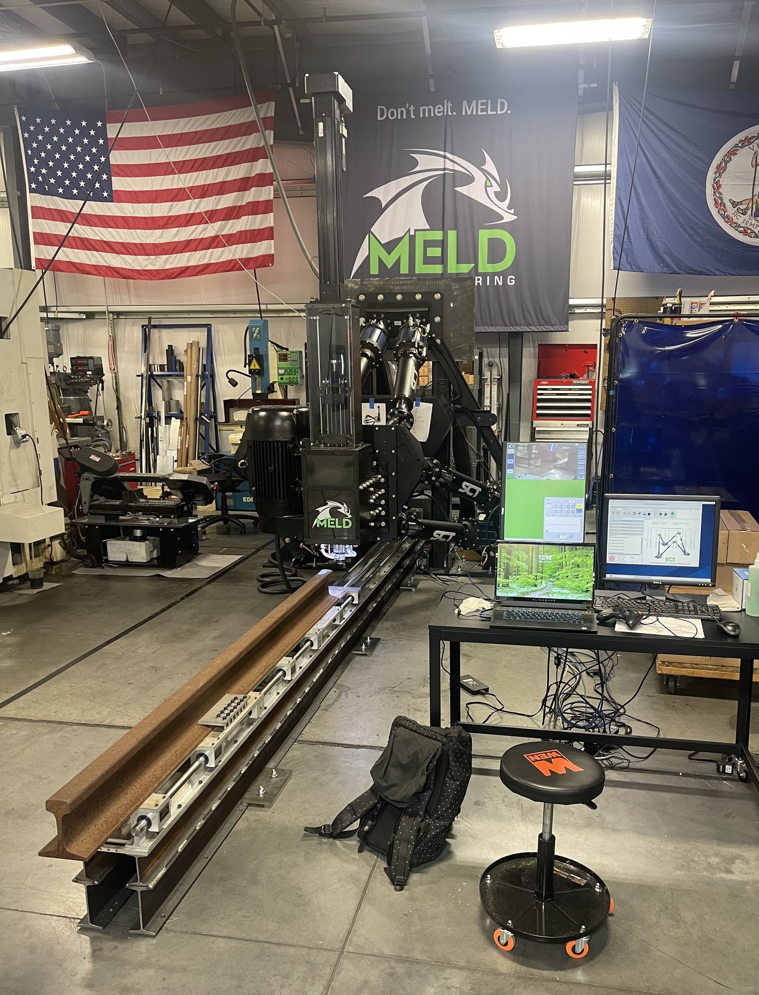 Full-scale MELD print head, Stewart platform, and rail mover system